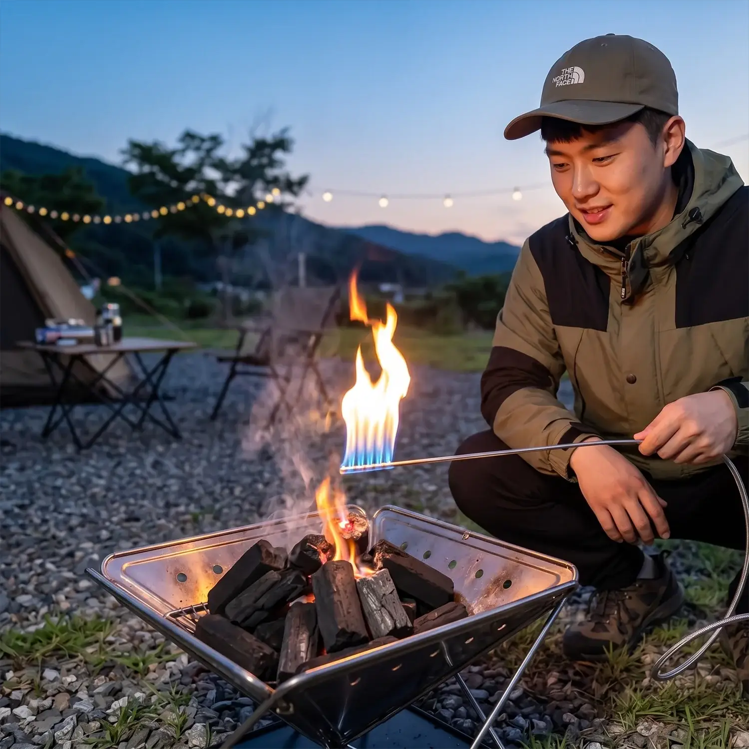 Simples Market Pandatour charcoal fire igniter spray gun used by a man at campsite wearing a The North Face cap