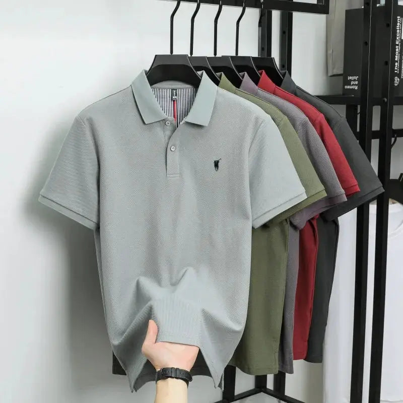 Polo shirts on hangers in assorted colors; light gray 100% cotton short-sleeve polo with embroidered pony logo
