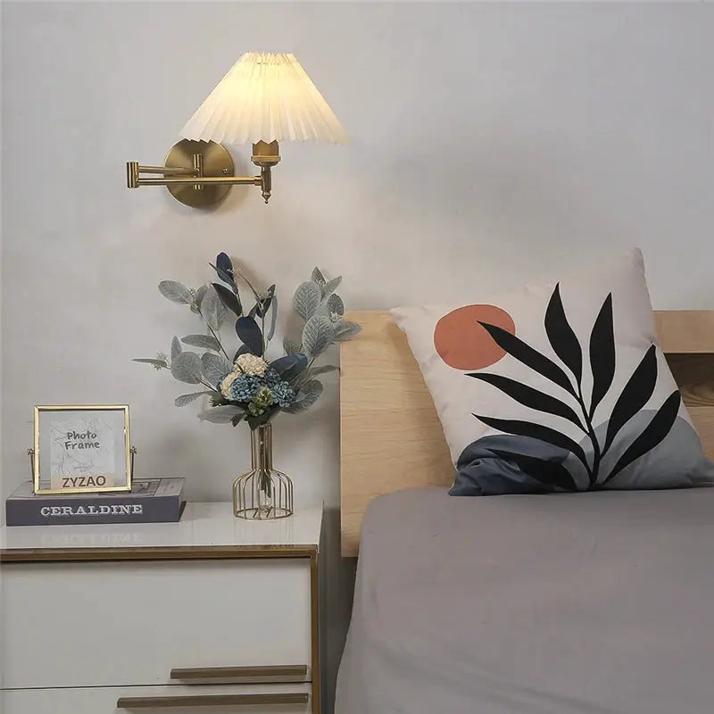 Nordic adjustable folding brass LED wall lamp with a pleated shade and rotating arm.