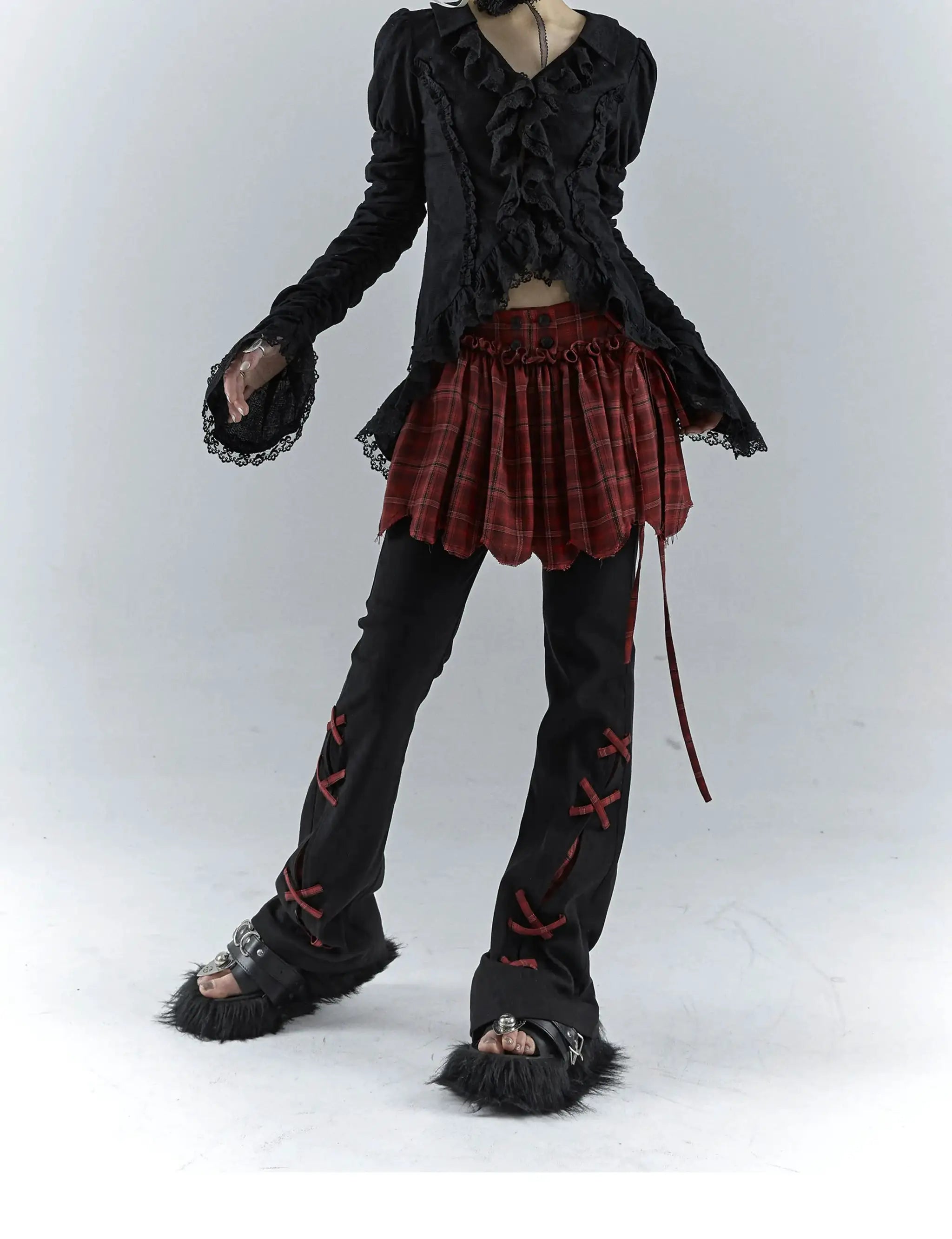 Karrcat Gothic black lace shirt with ruffle front and long lace cuffs, paired with a red plaid mini skirt.