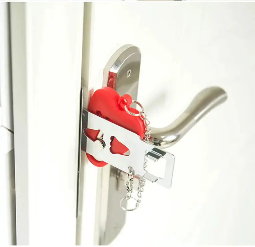 Portable door lock with red plastic body and silver metal bracket secured to a door handle
