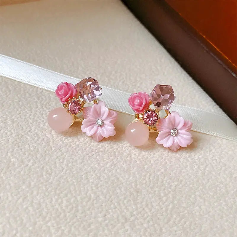 Pair of colorful flower earrings with pink petals, imitation pearl drops and faceted crystal studs