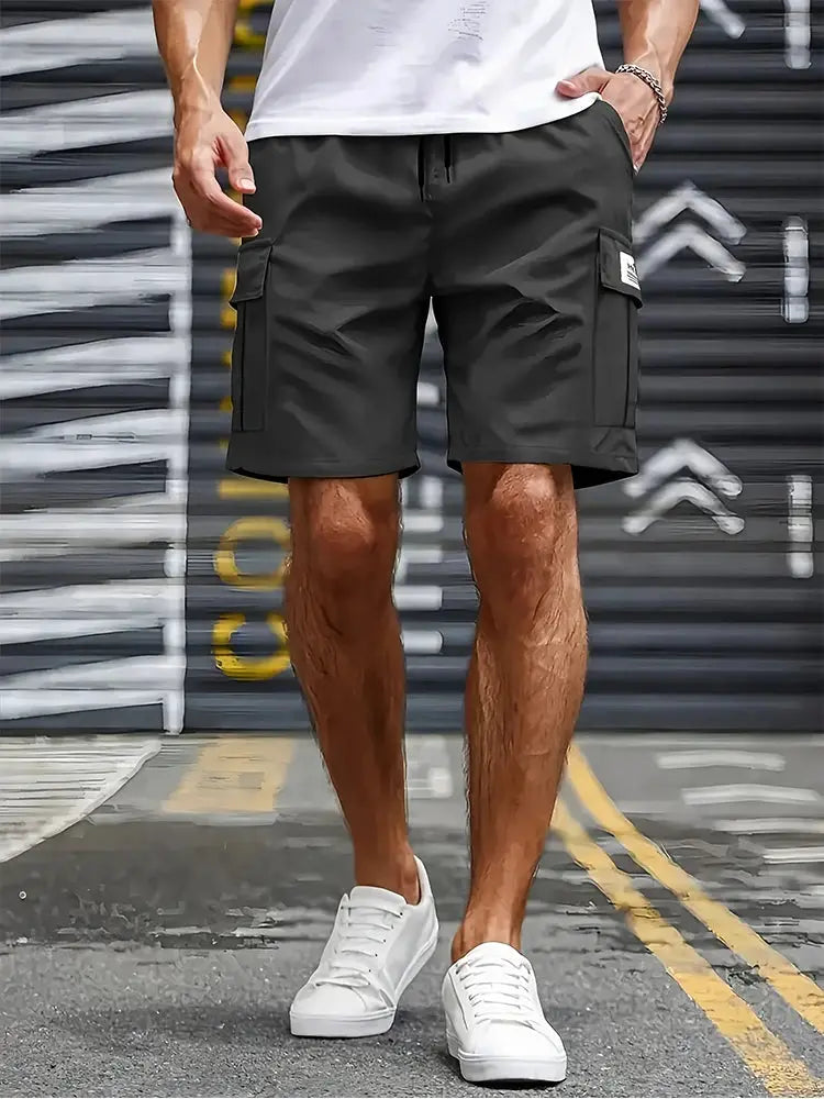Men's cargo shorts with large side pockets in black, loose-fit casual workwear.