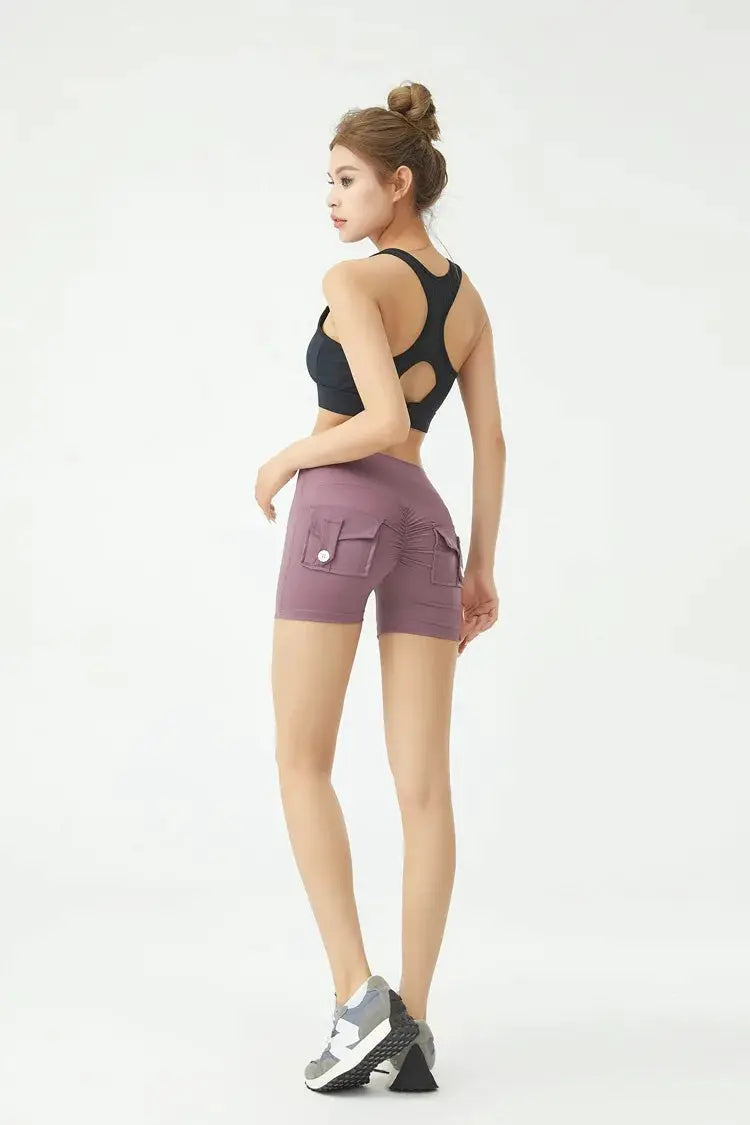 Peach Butt fitness shorts for women by Simples Market with cargo pockets, mauve-purple, mid-thigh length