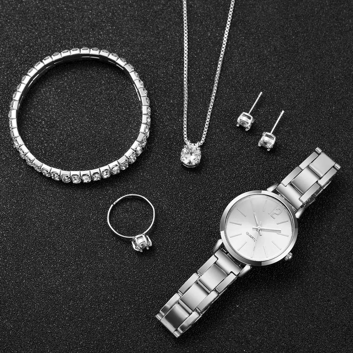 6-piece silver-tone women's jewelry set: stainless steel quartz watch, bracelet, pendant necklace, ring, and earrings.