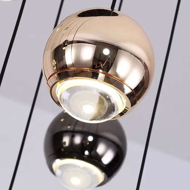 Pendant lights set of 2 spherical LED ring fixtures in copper-gold and black finishes by Simples Market