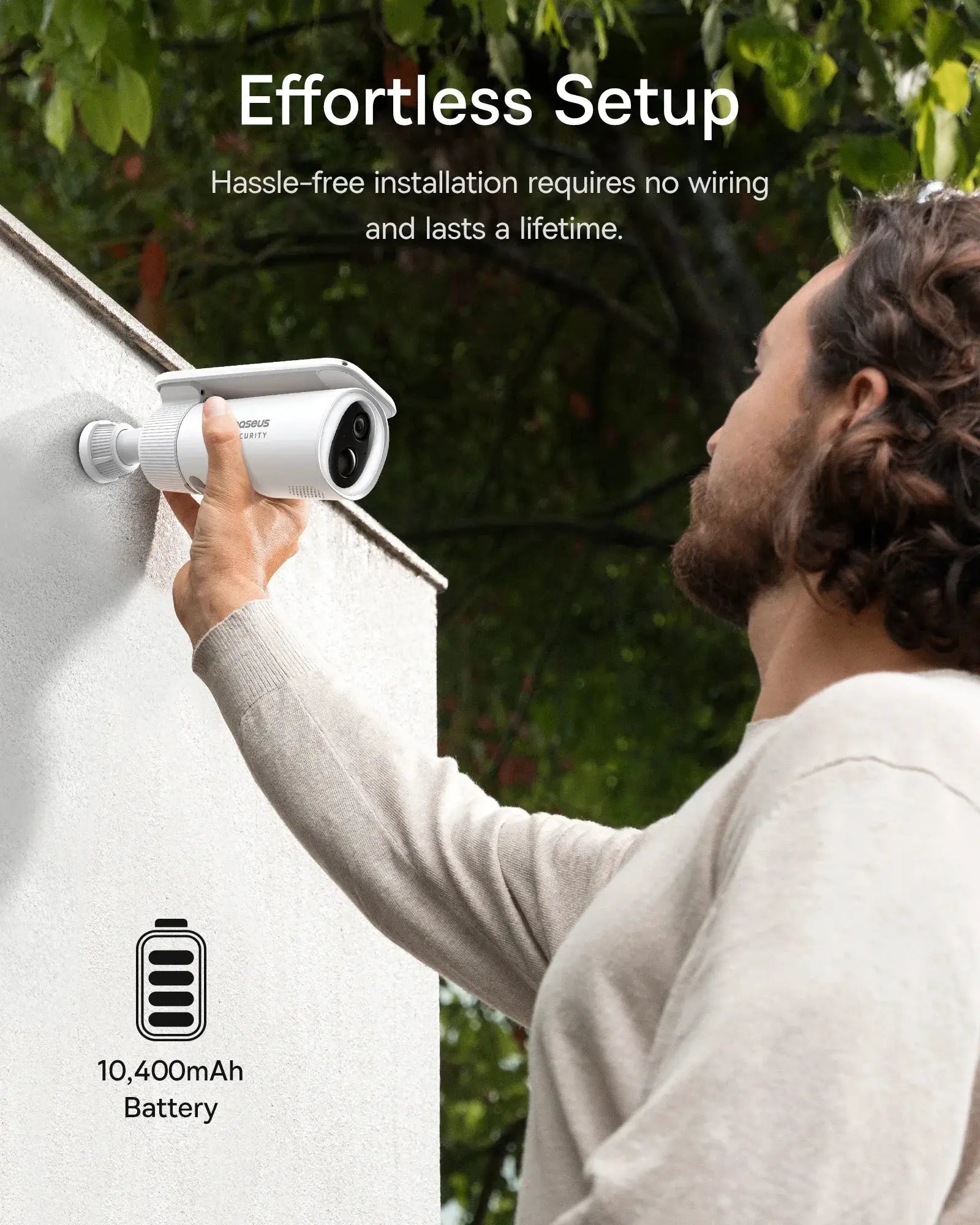Baseus Security S1 outdoor camera, white, being installed on a wall; 10,400mAh battery label visible