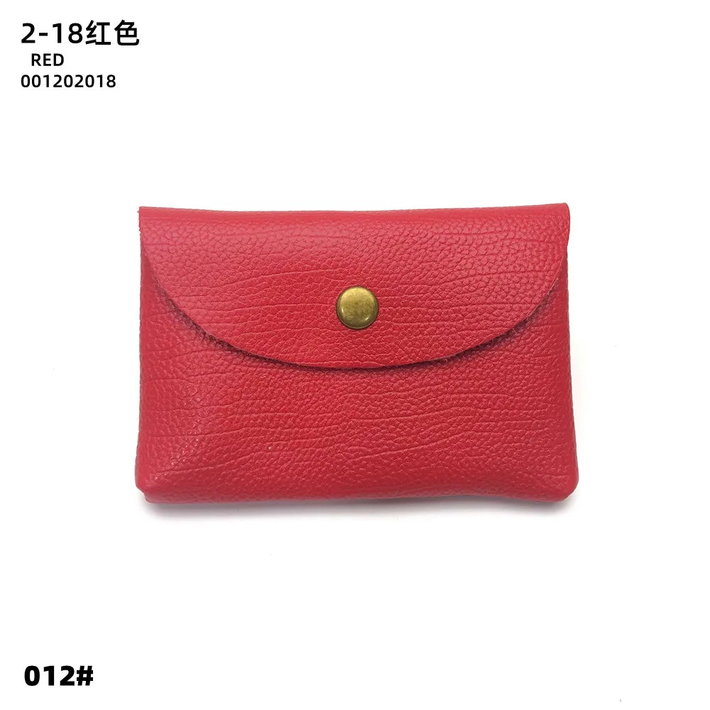 Red genuine leather card holder by Simples Market with brass snap, compact envelope-style design