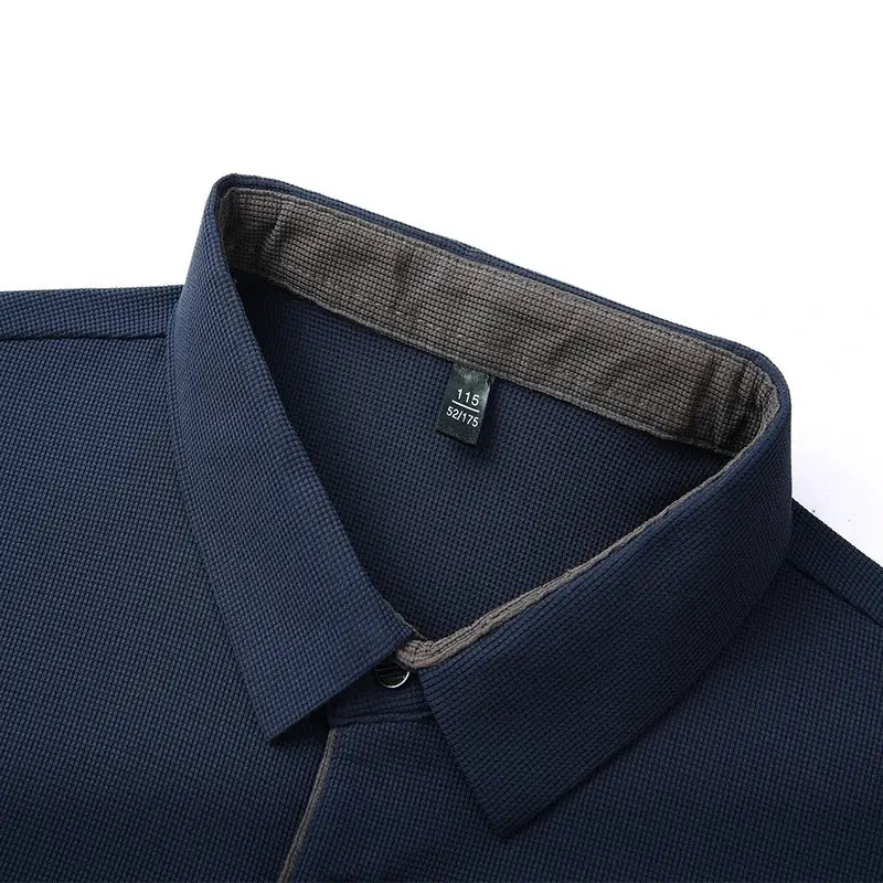 Navy blue men's long-sleeve polo shirt with textured fabric and classic collar.
