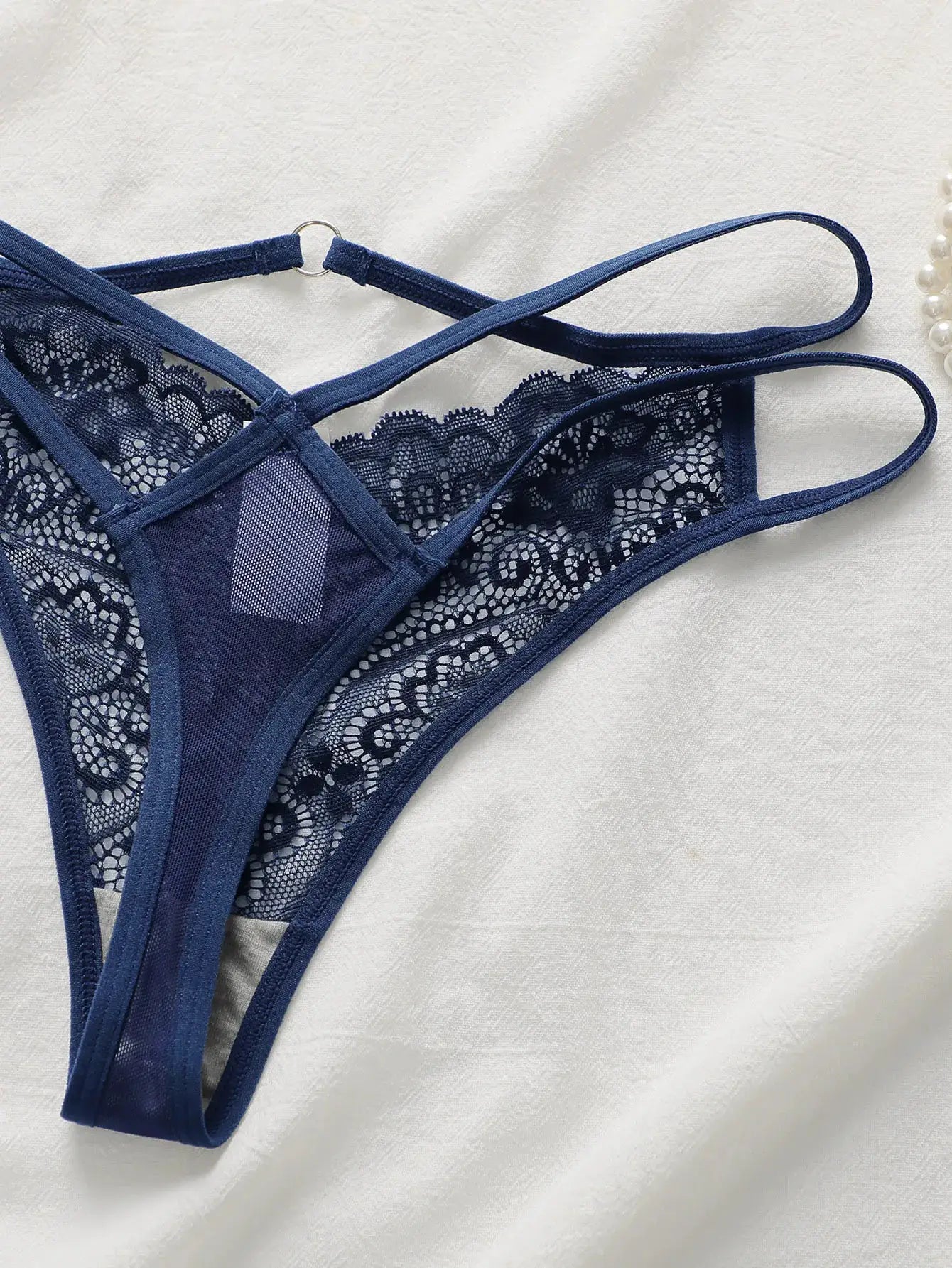 Lace thong underwear by Simples Market in navy blue; lightweight lace fabric.
