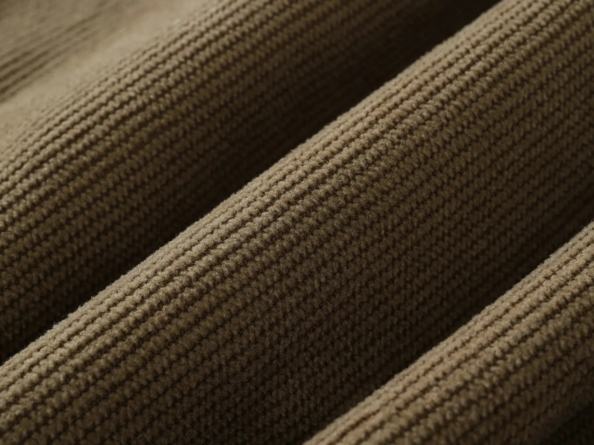 Corduroy shorts fabric close-up in brown, textured ribbed material suitable for summer casual wear.