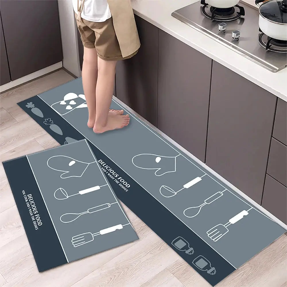 Two long non-slip kitchen mat runners in blue-gray crystal velvet with utensil icon designs for the kitchen floor.