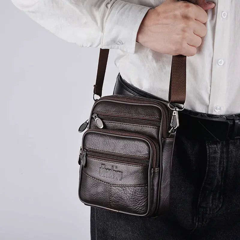 Men's genuine leather crossbody bag in dark brown with multiple zipper pockets and adjustable strap