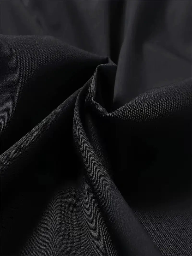 Men's sports shorts fabric close-up in black, textured weave detail