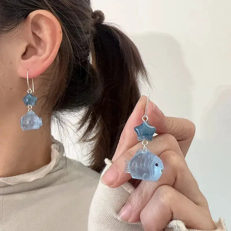 Blue transparent goldfish pendant earrings with star drop beads, pair from Simples Market