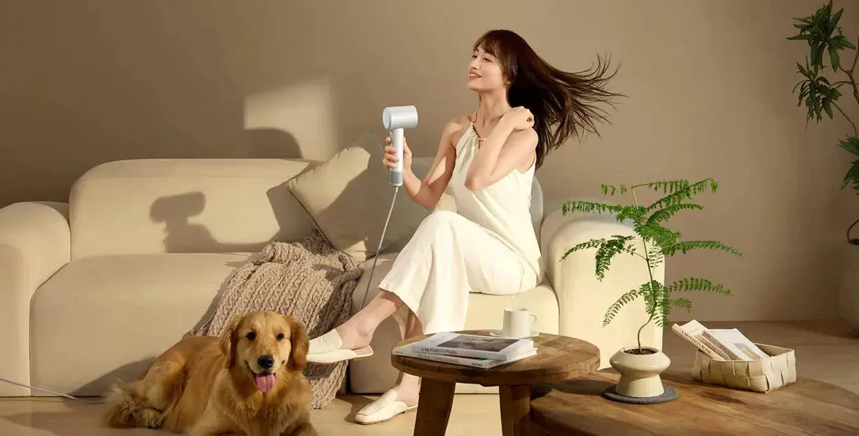 MIJIA H501 SE hair dryer, white; 62 m/s wind in a living room with a smiling woman and a golden retriever