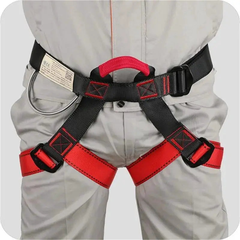 Simples Market outdoor climbing harness with black and red straps, metal D-ring and adjustable buckles.