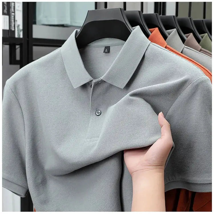 Simples Market men's 100% cotton polo shirt in gray on a rack of assorted colors