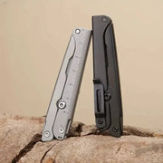 Portable folding scissors multitool; two compact tools shown, one with a stainless steel ruler