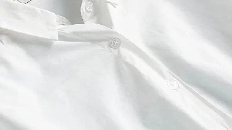 White long-sleeve shirt with turn-down collar and front button placket