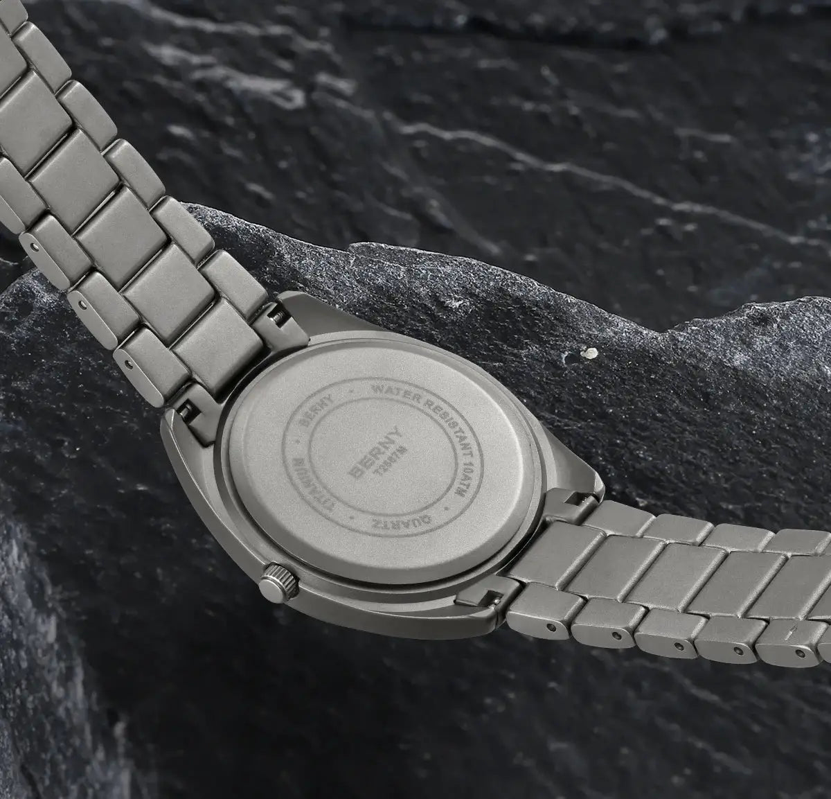 BERNY titanium men's watch with gray metal bracelet; back view showing water-resistant engraving.
