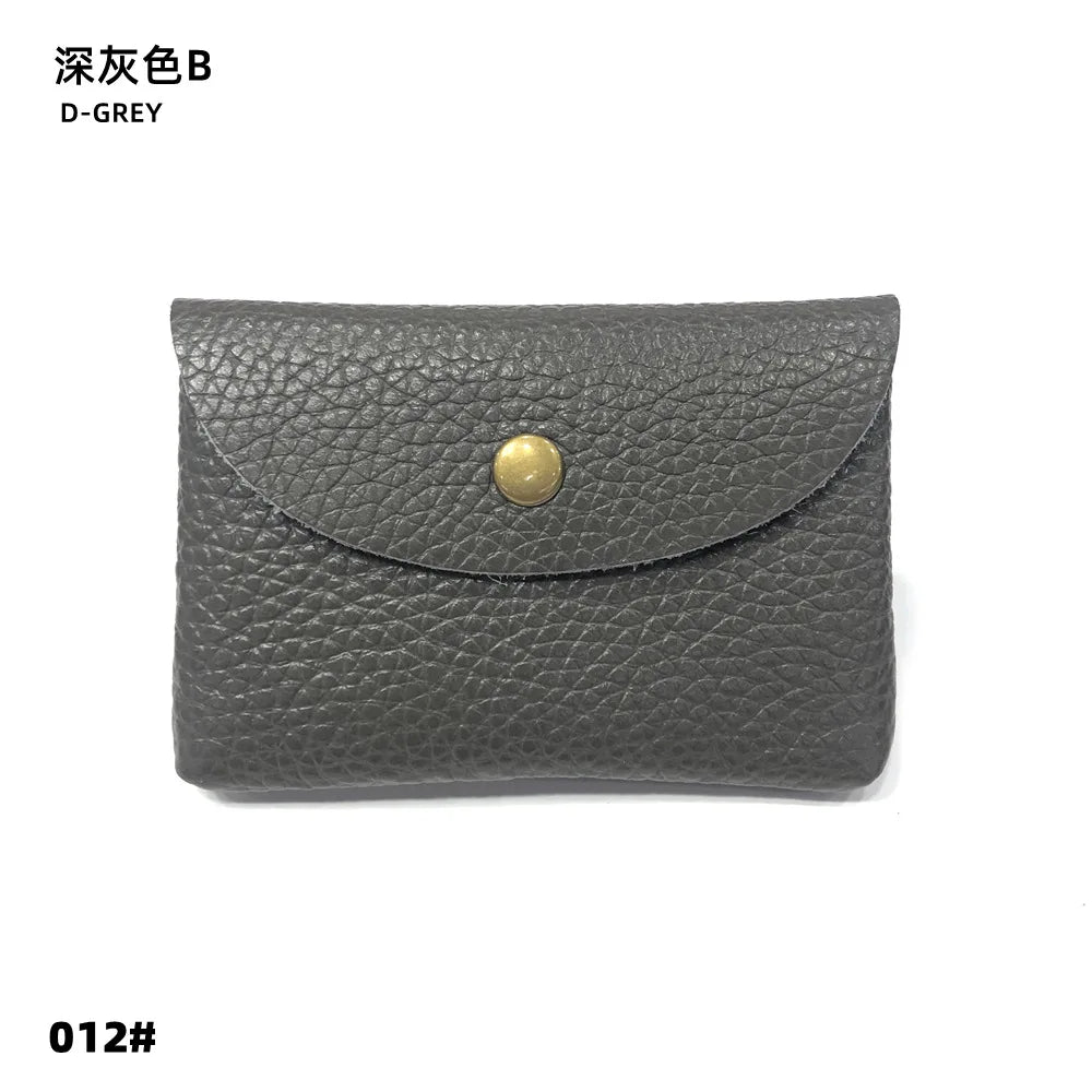 Leather card holder from Simples Market in genuine deep gray with brass snap closure.