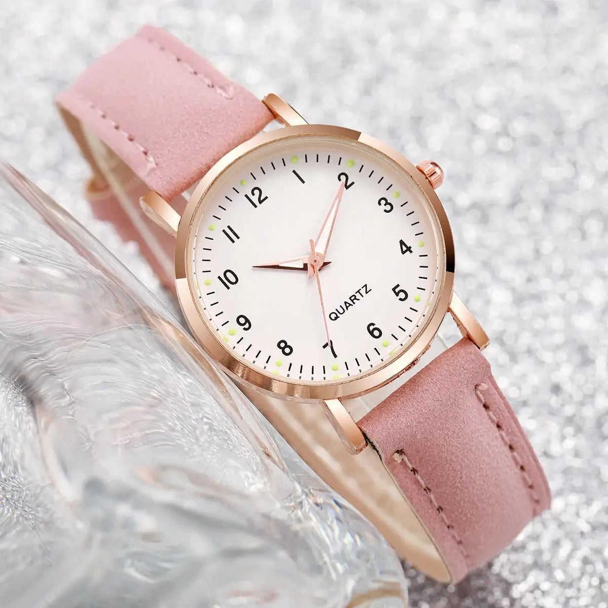Women's pink leather strap quartz wristwatch by Simples Market with rose-gold case and white Arabic numeral dial
