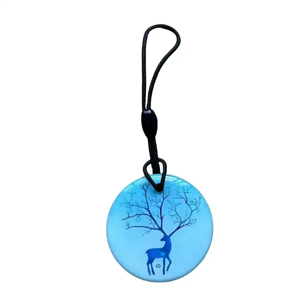 RFID key tag blue round disc with deer and tree graphic on a black lanyard
