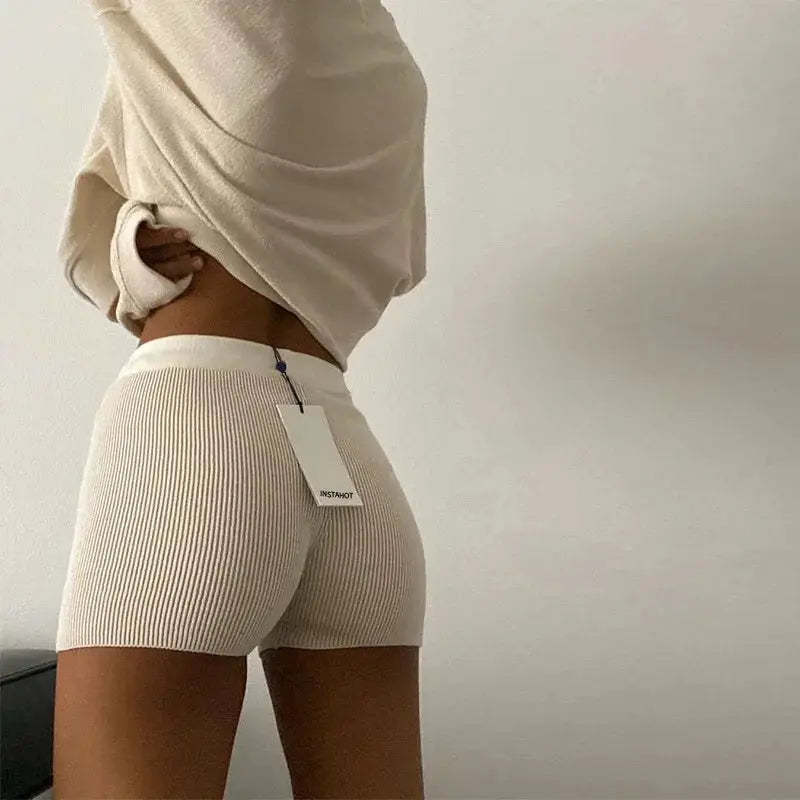 Summer knitted shorts in cream ribbed cotton, high-waist yoga-biker style with tag visible