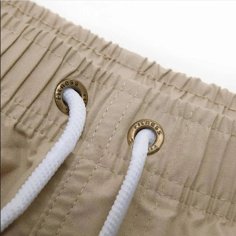 Men's board shorts beige quick-dry swim trunks with white drawstrings and metal grommets