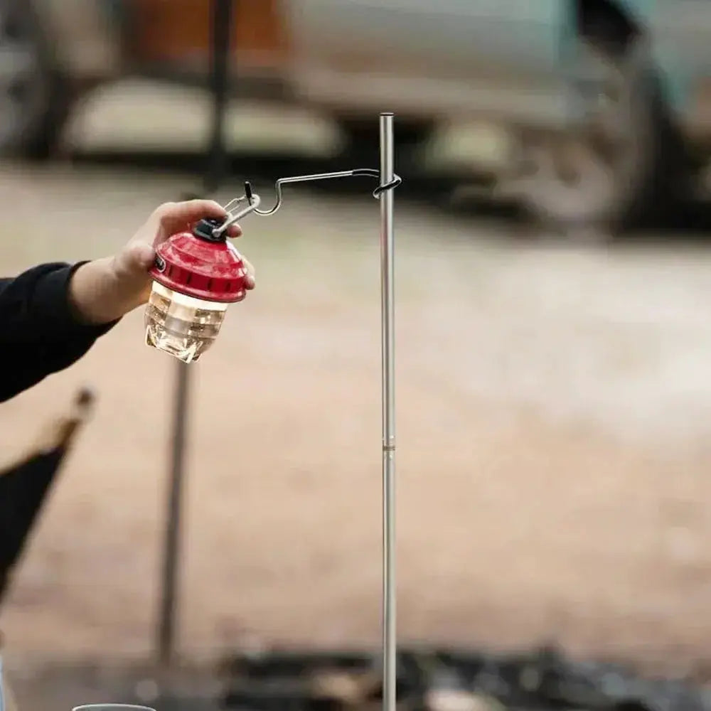 Lantern hanger for camping on a metal light stand with a red lantern