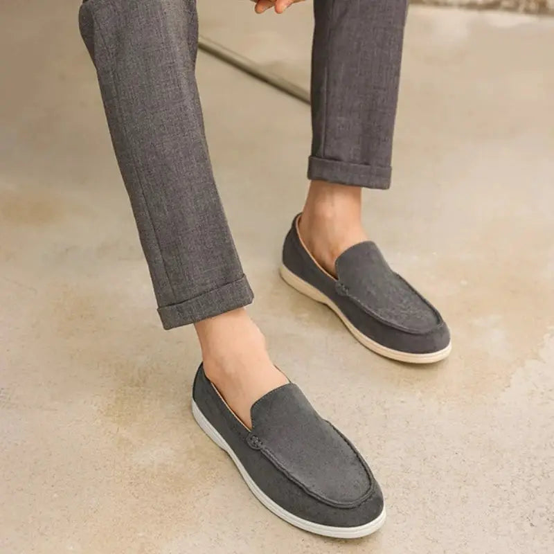 Men's dark gray suede loafers, lightweight slip-on moccasins with beige sole.