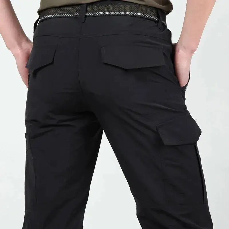 Military tactical cargo pants for men in black with back flap pockets and side cargo pockets; waterproof