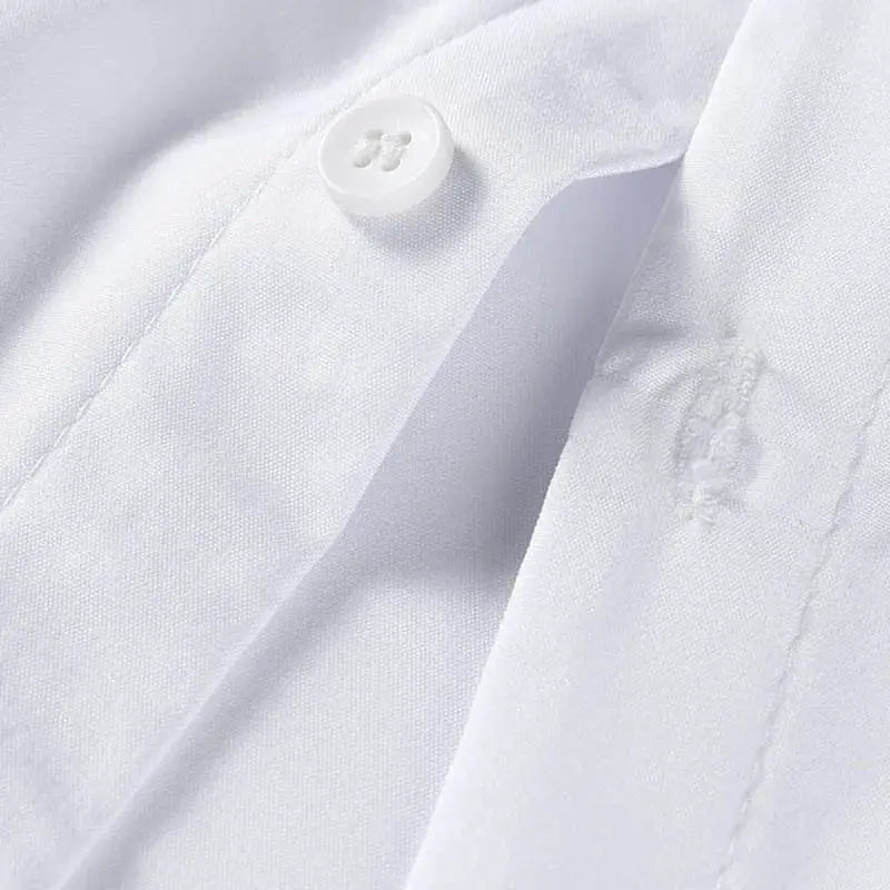 Men's white solid-color short-sleeve shirt close-up of button and fabric texture