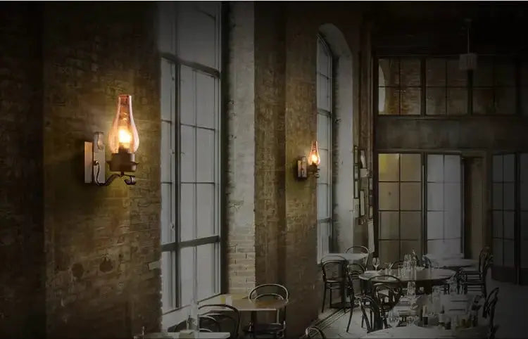 Wall lamp, wrought iron, industrial loft style, warm amber glow against brick restaurant wall