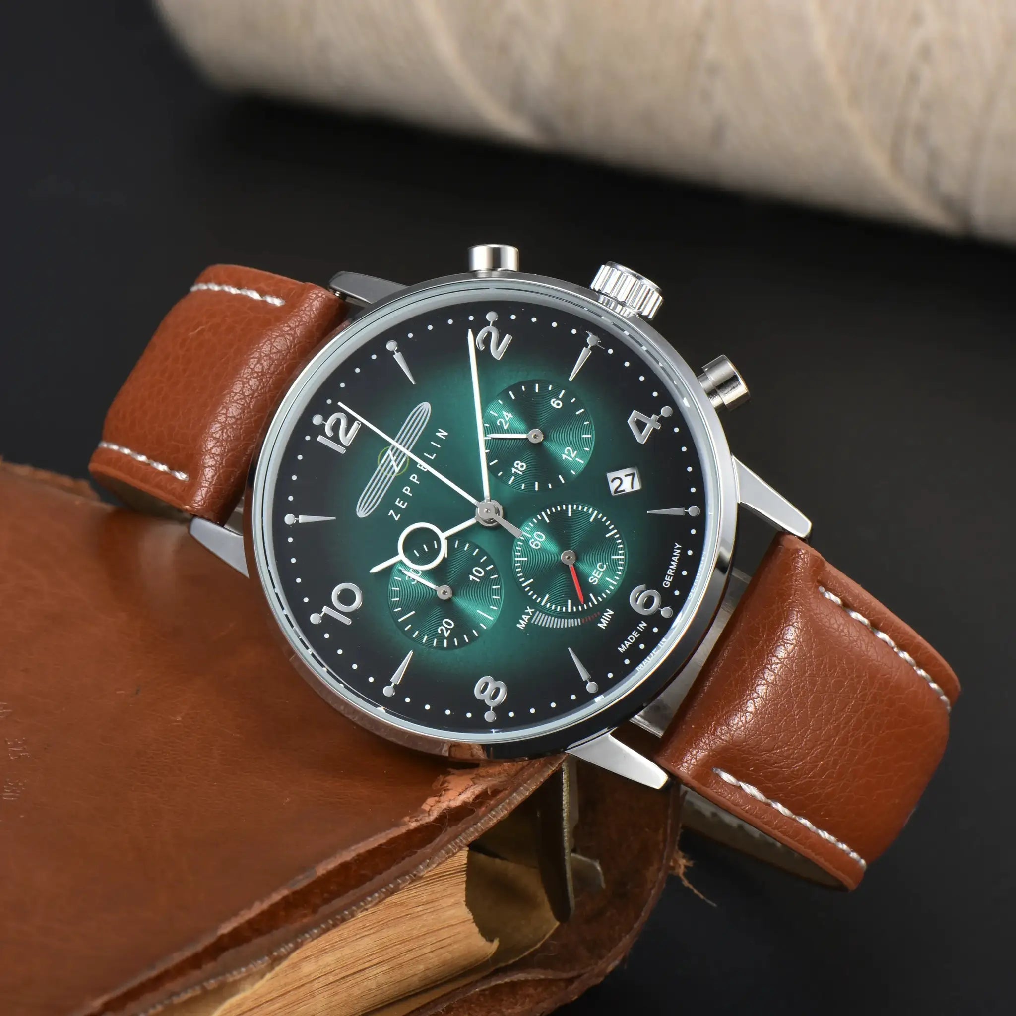 Zeppelin chronograph watch with brown leather strap and green dial.