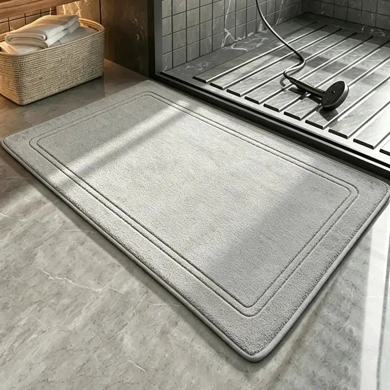 Simples Market grey bathroom rug, soft plush non-slip bath mat placed in front of a glass shower.
