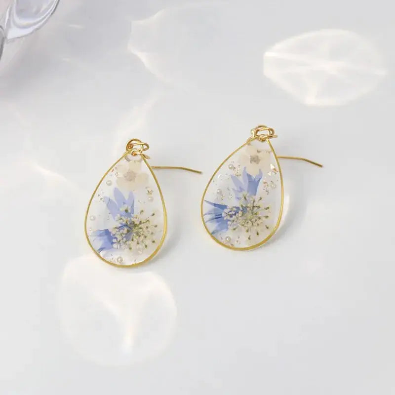 Simples Market teardrop epoxy resin flower earrings with gold frame, blue pressed blooms, pair