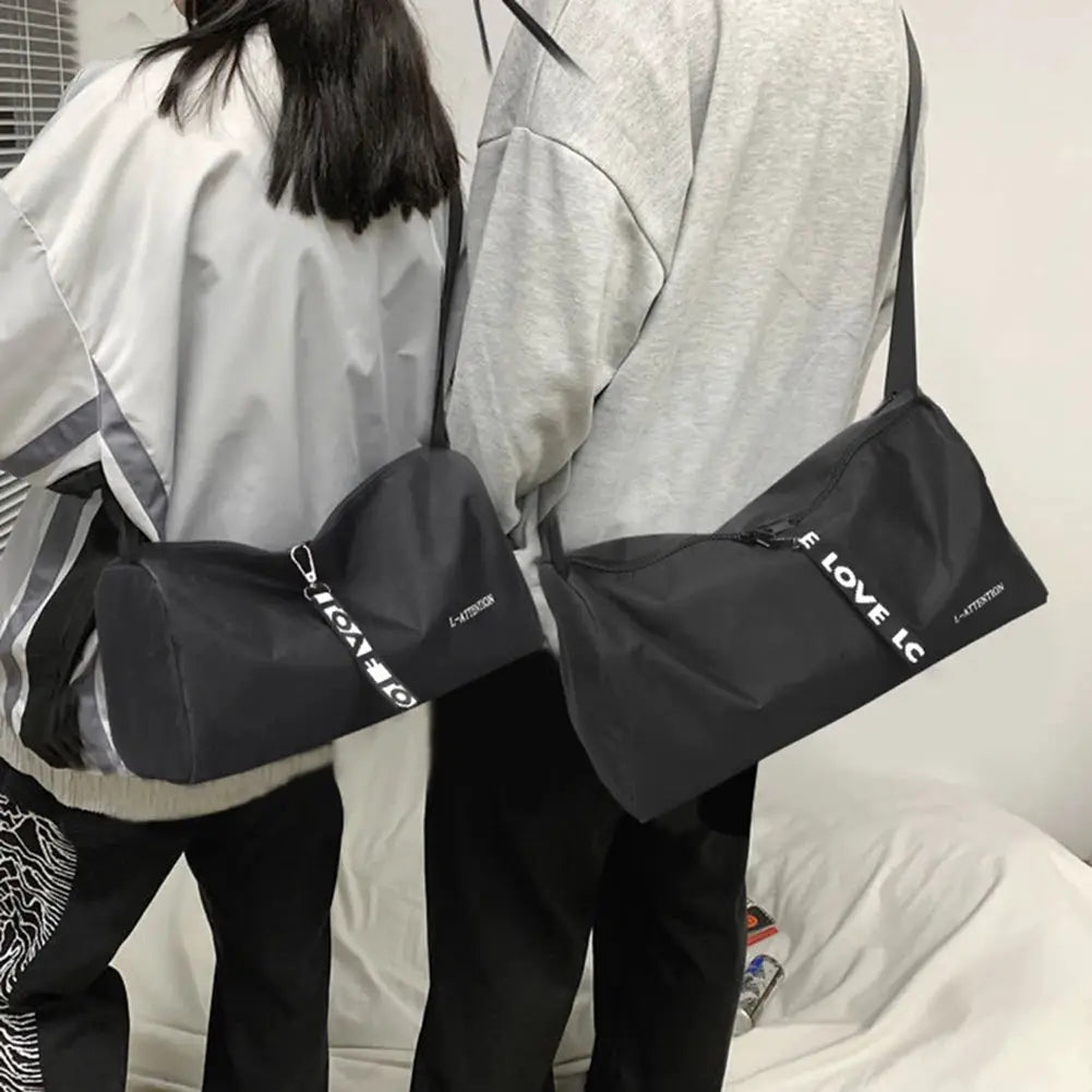 Two black sport gym bags with shoulder straps, waterproof, large-capacity with separate shoe compartments.
