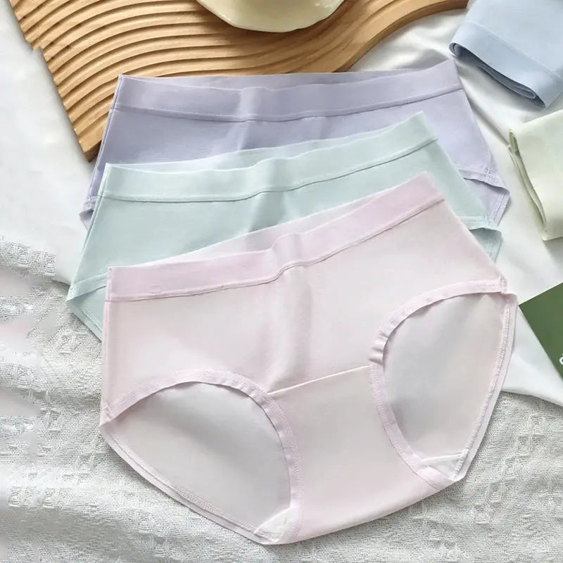 7-piece women's cotton panties set in pastel colors (pink, mint, lavender) laid flat.