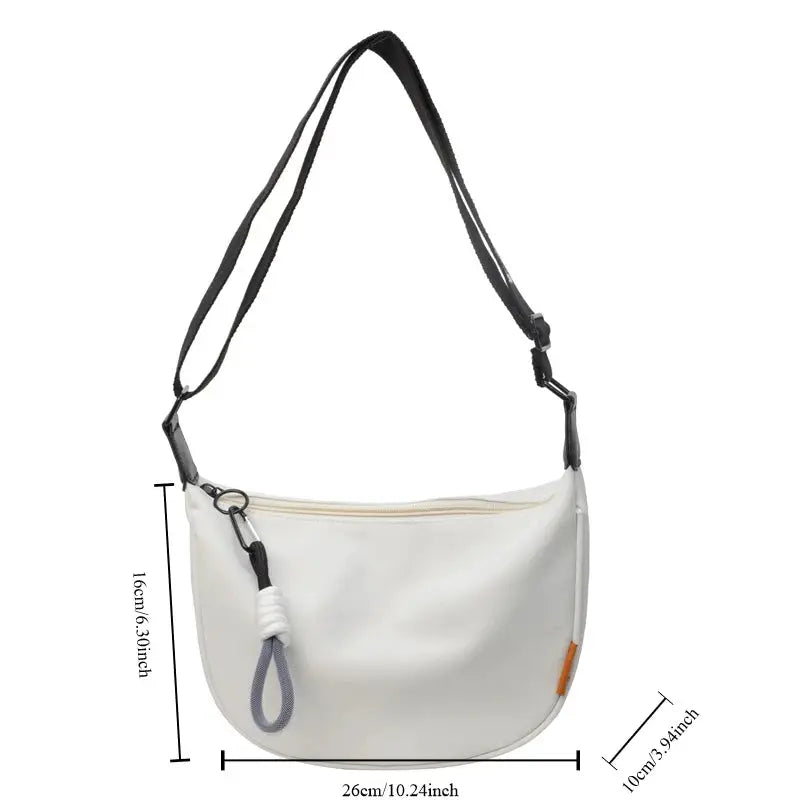 White dumpling-style crossbody bag with wide black strap, top zipper and decorative rope loop