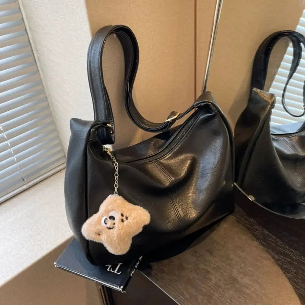 Black PU leather slouchy shoulder bag with teddy bear keychain, large-capacity hobo tote