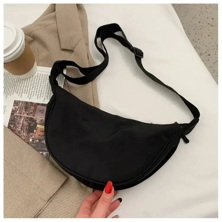 Nylon dumpling bag, black lightweight crossbody with adjustable strap.