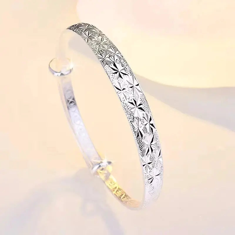 Sterling silver bangle bracelet with Gypsophila star pattern and gold-toned interior