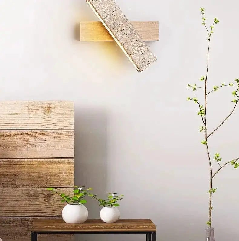 Natural stone wall lamp sconce with a concrete-textured block on wooden mount