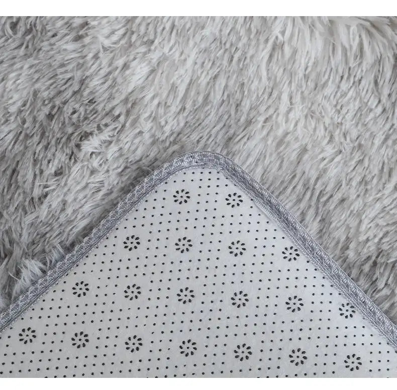 Kids plush rug with grey shag surface and white dotted backing