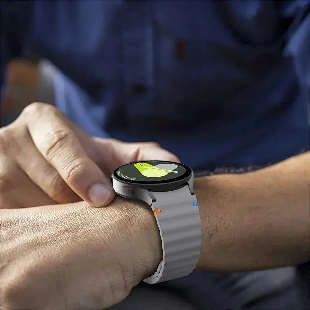 Silicone Galaxy Watch strap by Simples Market; white 44/40mm sport band with orange and blue accents.