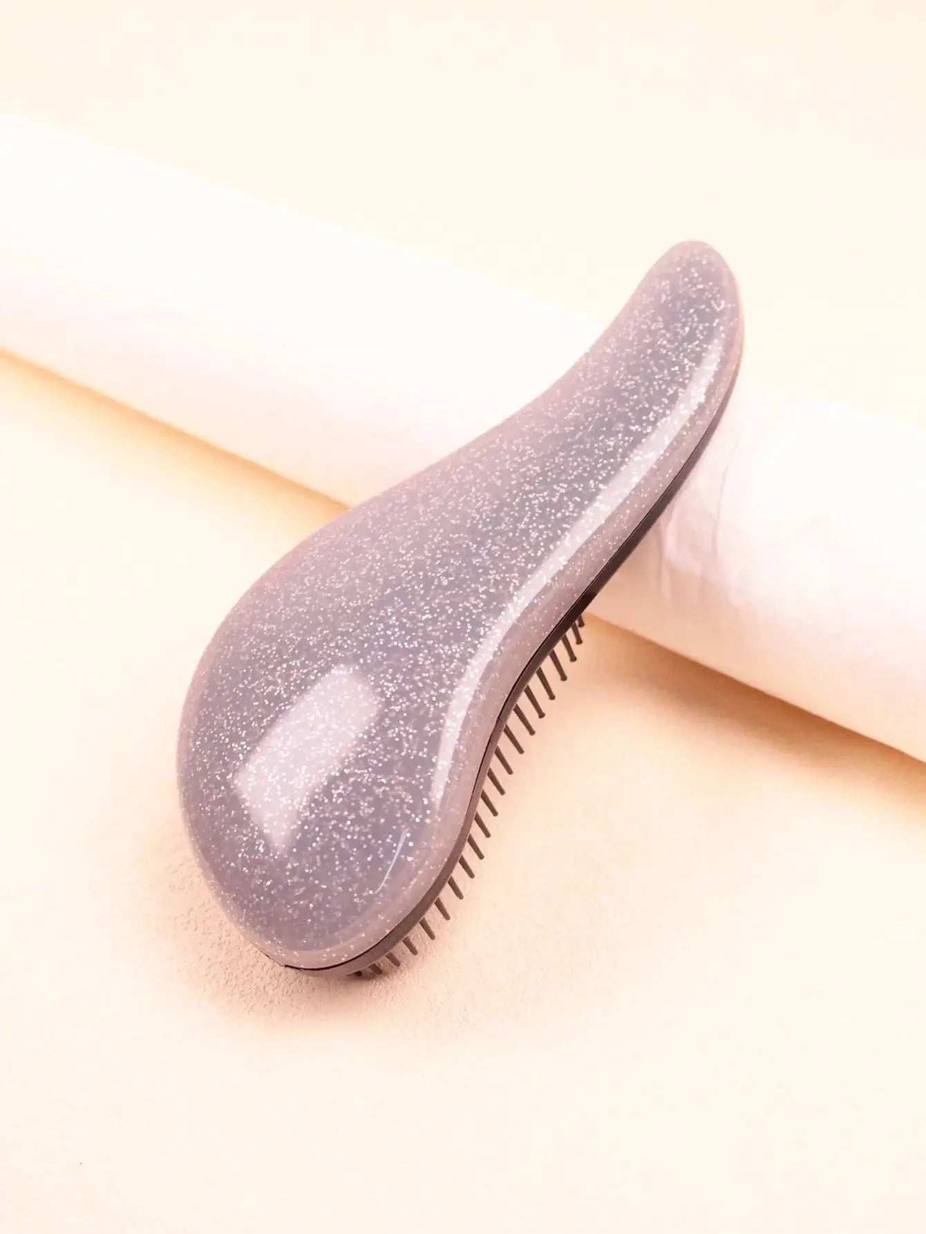 Smoothing brush by Simples Market with a speckled gray handle and fine bristles