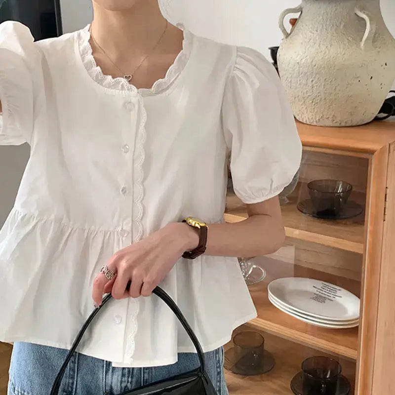 White puff-sleeve peplum blouse for women with lace-trim neckline and button front