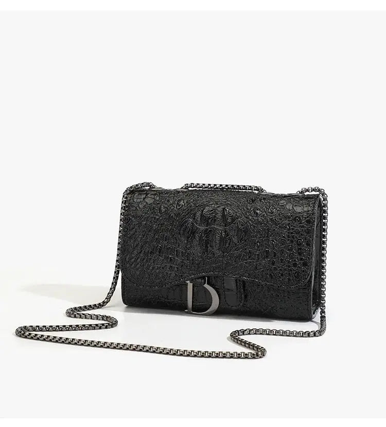 Women's crocodile-embossed black crossbody handbag with silver chain strap